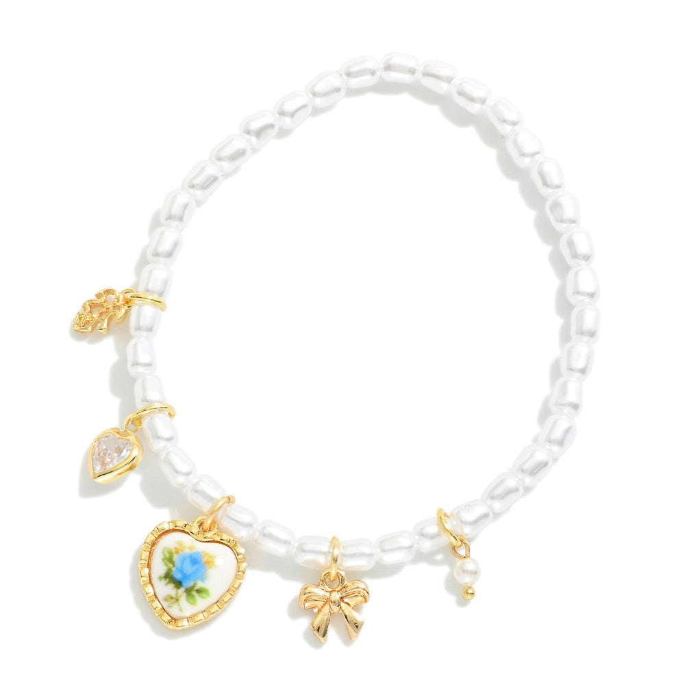 Pearl Beaded Stretch Bracelet Featuring Vintage Porcelain Blue Rose Heart Charm, Bow, Rhinestone Heart, And Leaf Charms