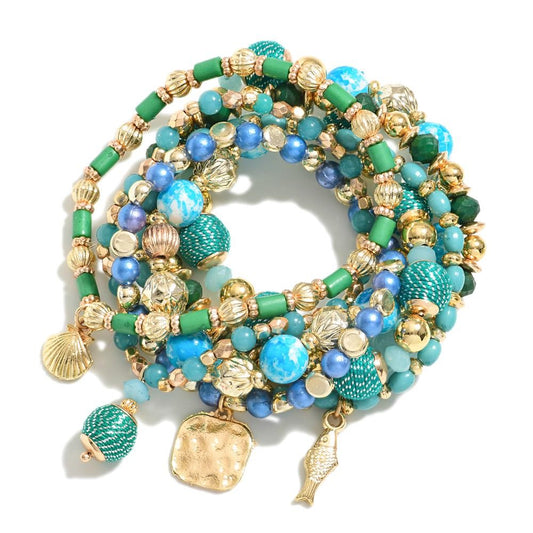 Set of Seven Beaded Stretch Bracelets Featuring Gold Tones & Textured Beads With Beach Charms