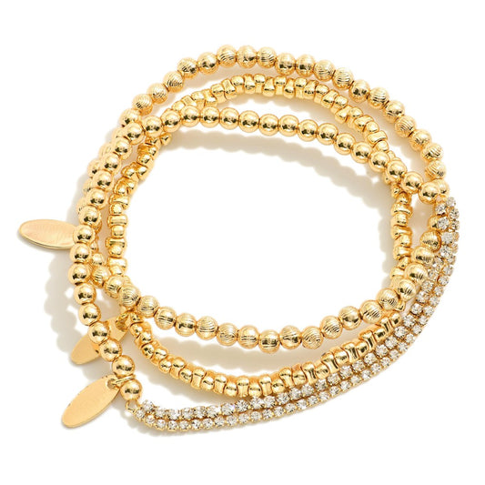 Set Of Three Metal Tone Beaded Stretch Bracelets Featuring Flat Oval Charms & Rhinestone Details