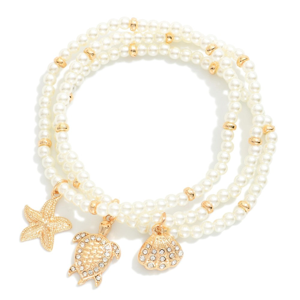 Set Of Three Faceted Bead Stretch Bracelets Featuring Metal Tones, & Beach Charms - Cream